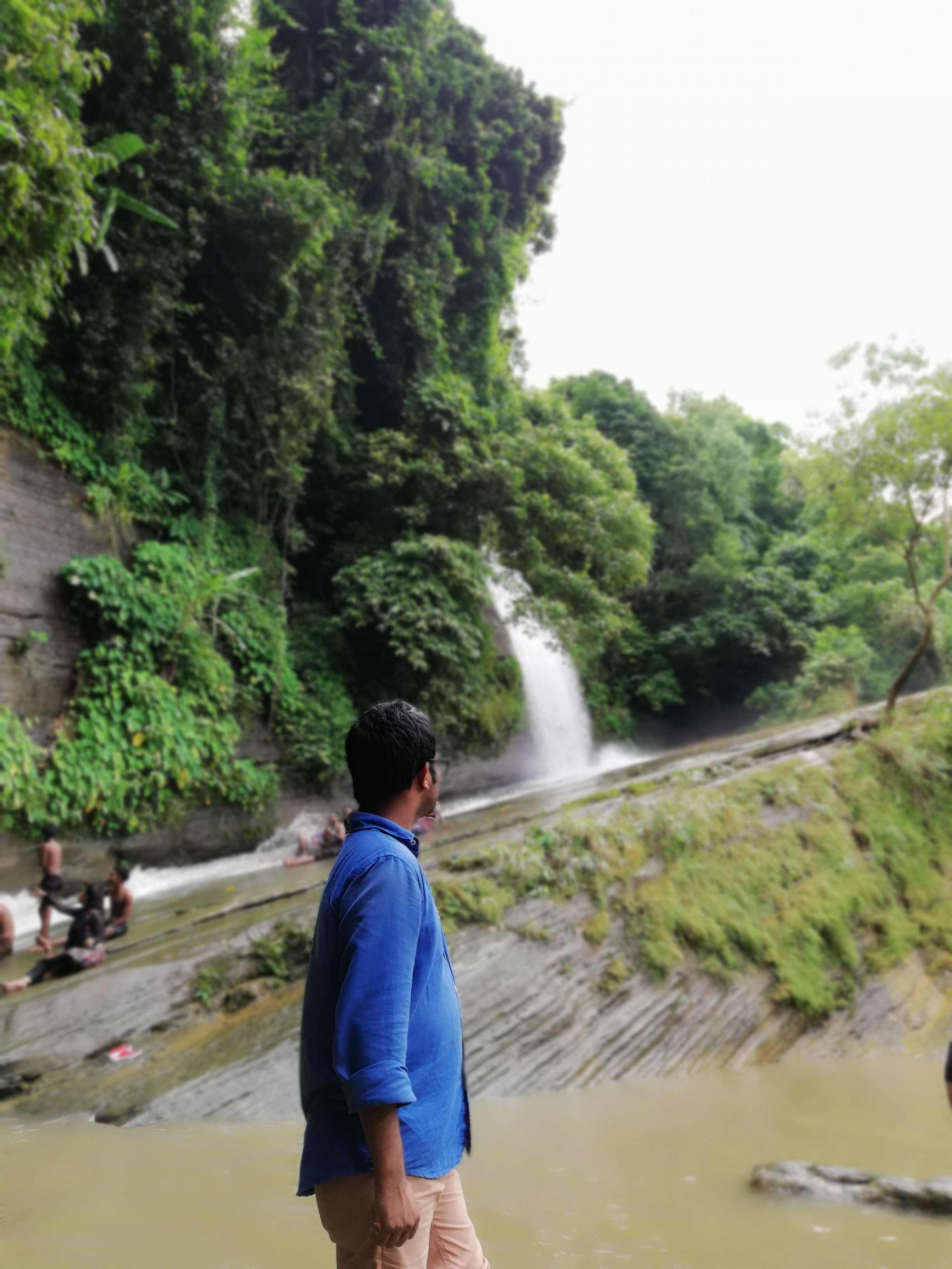 A man looking at Risang Waterfall